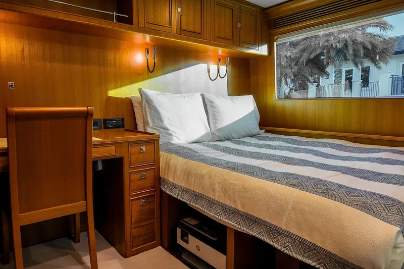 Slide: The Image of Luxurious Marlow Voyager Series 2022 yacht interior with elegant wood paneling and cozy bedding. - 26