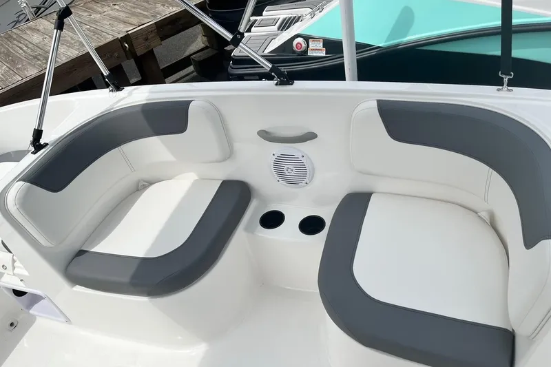Slide: The Image of 2026 Bayliner Element E16 boat interior with gray and white seating and cup holders. - 13