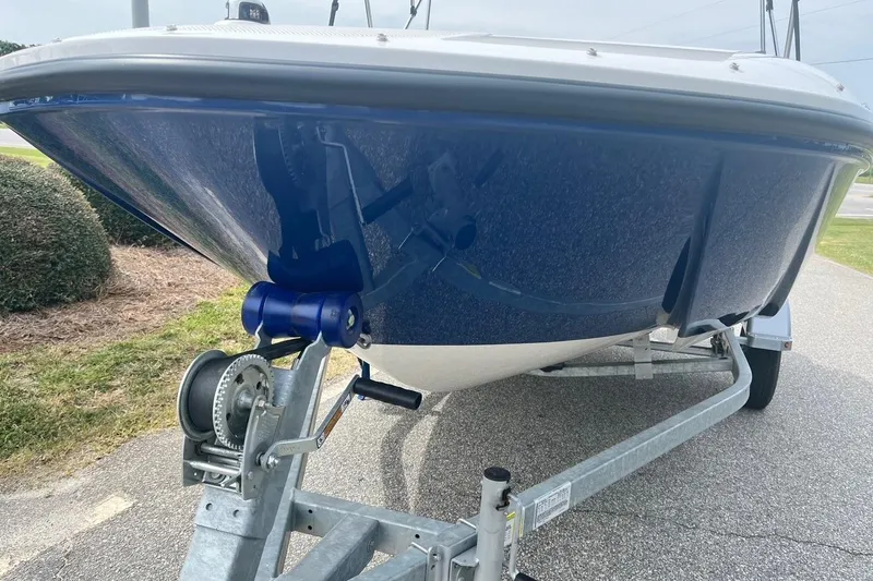 Slide: The Image of 2026 Bayliner Element E16 boat on trailer, blue hull, parked outdoors. - 5