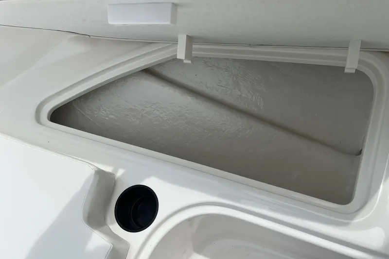 Slide: The Image of Storage compartment of 2026 Bayliner Element E16 boat, featuring sleek white interior design. - 8