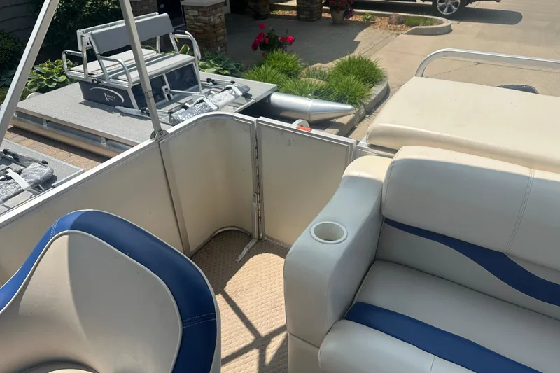 Slide: The Image of 2004 Crest 20 II LM pontoon boat interior with blue and white seating. - 12