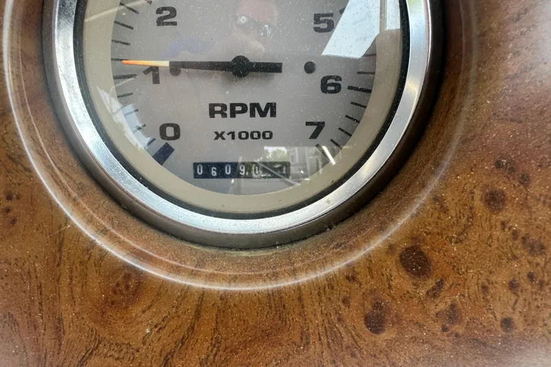 Slide: The Image of Close-up of a 2004 Crest 20 II LM RPM gauge, showing 6090 hours. - 14