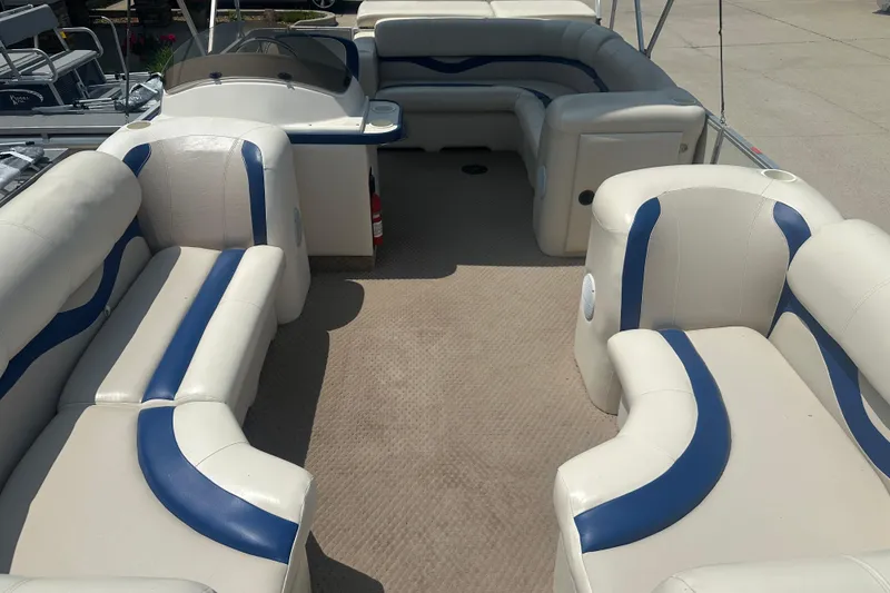 Slide: The Image of 2004 Crest 20 II LM pontoon boat with spacious seating and blue accents. - 3