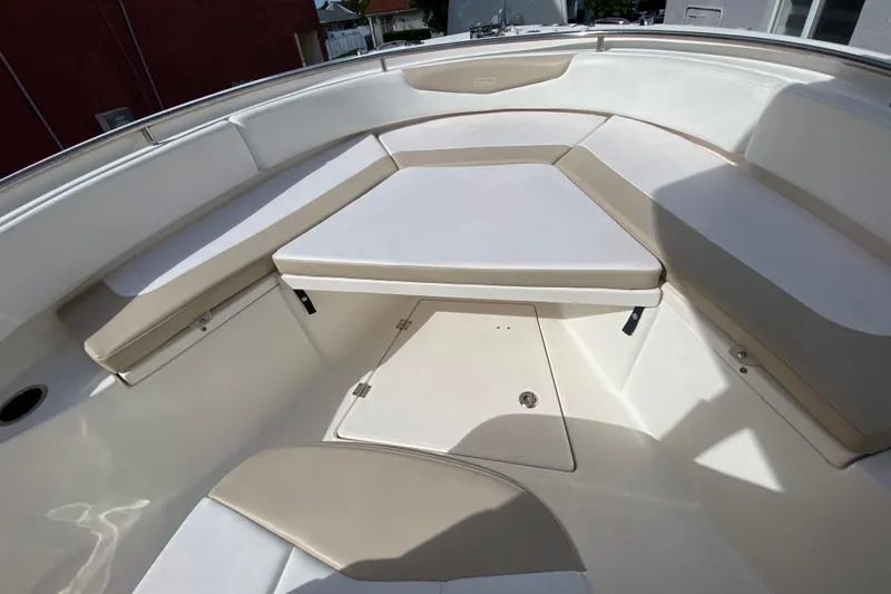 Slide: The Image of 2018 Robalo R242 Center Console boat interior with cushioned seating and storage. - 15