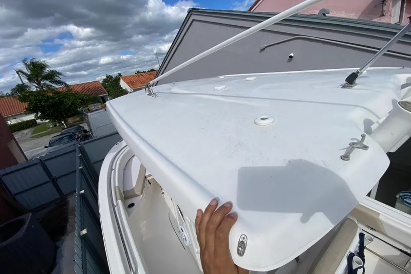 Slide: The Image of 2018 Robalo R242 Center Console boat with white hardtop, viewed from above. - 39