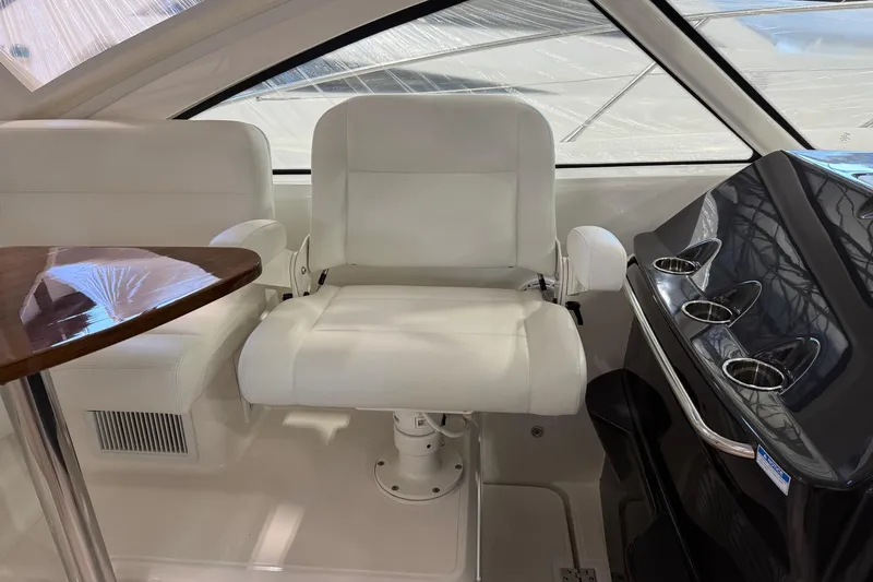 Slide: The Image of 2023 Tiara Yachts 43 Open interior with white seating and sleek helm design. - 13