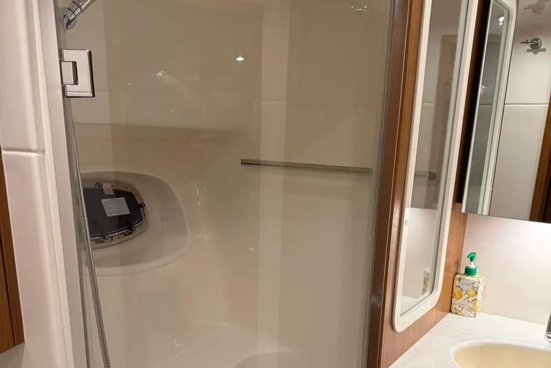 Slide: The Image of 2023 Tiara Yachts 43 Open bathroom with shower and sink area. - 19