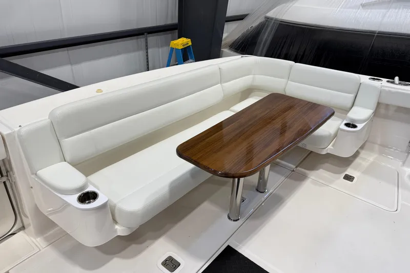 Slide: The Image of 2023 Tiara Yachts 43 Open interior with white seating and wooden table. - 4