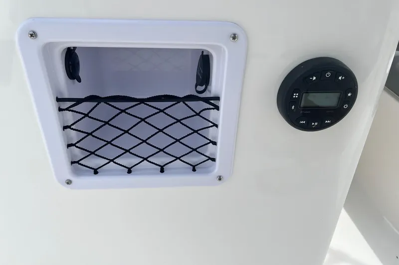 Slide: The Image of Bayliner Element E16 2026, storage compartment and control panel. - 15