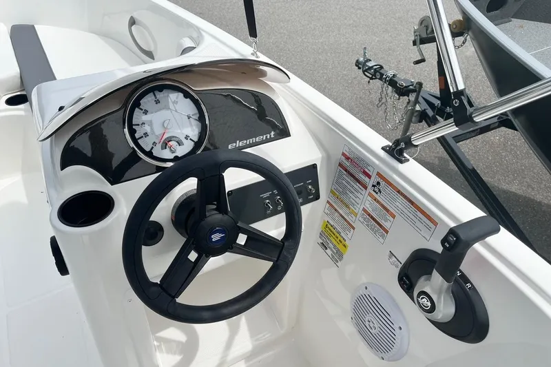 Slide: The Image of 2026 Bayliner Element E16 boat dashboard with steering wheel and control panel. - 11