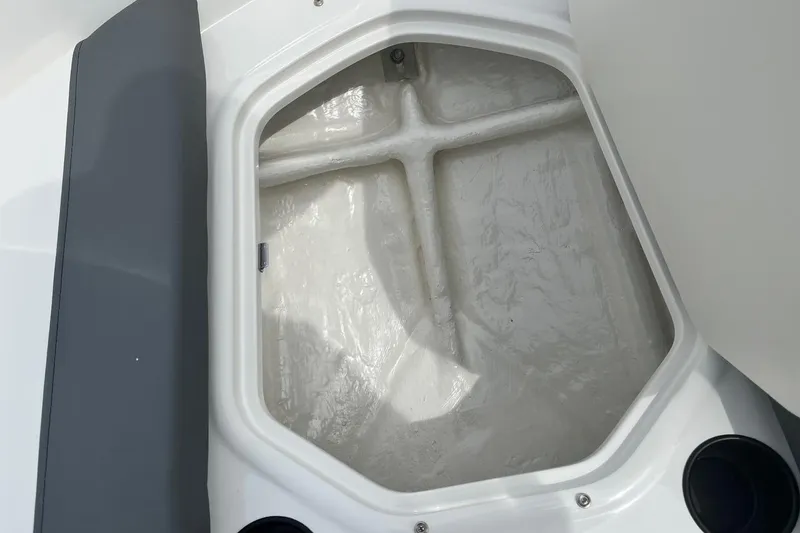 Slide: The Image of Storage compartment of 2026 Bayliner Element E16 boat, featuring a clean, white interior. - 7
