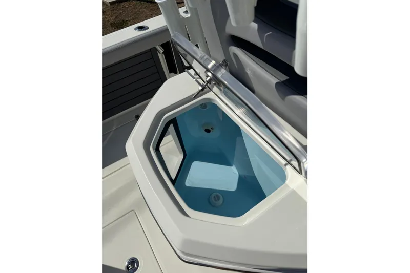 Slide: The Image of 2026 Pathfinder 2400 Open boat storage compartment with open lid, showcasing interior design. - 16