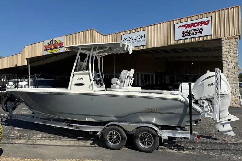 Slide: The Image of 2026 Pathfinder 2400 Open boat on trailer outside dealership. - 2