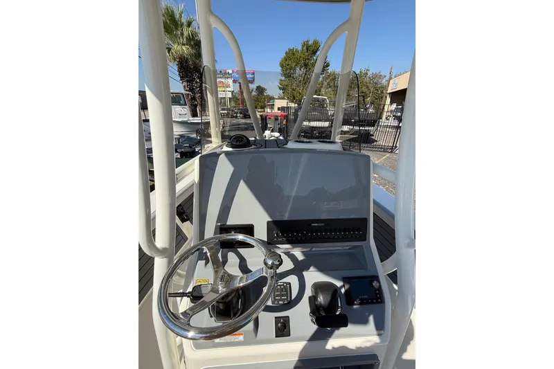 Slide: The Image of 2026 Pathfinder 2400 Open boat console with steering wheel and navigation controls. - 24