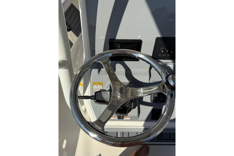Slide: The Image of Steering wheel of 2026 Pathfinder 2400 Open boat, featuring sleek design and controls. - 26