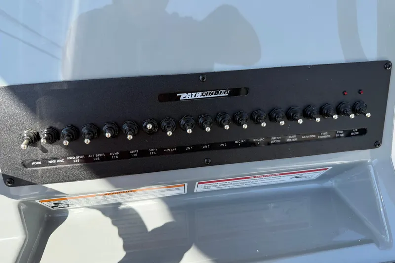 Slide: The Image of Control panel of 2026 Pathfinder 2400 Open boat with labeled switches. - 28