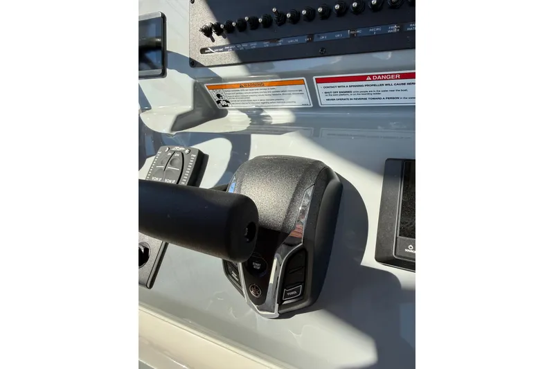 Slide: The Image of Control panel of 2026 Pathfinder 2400 Open boat, featuring throttle and switches. - 30