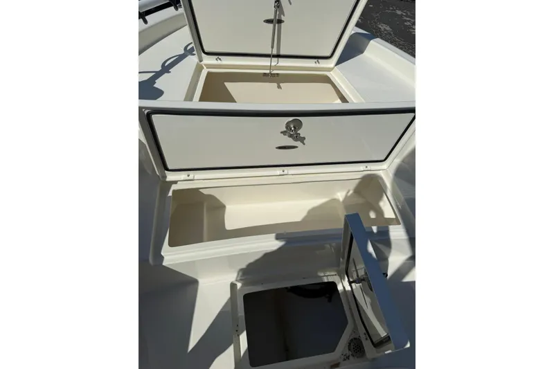 Slide: The Image of 2026 Pathfinder 2400 Open boat storage compartments, open and empty, showcasing interior space. - 41