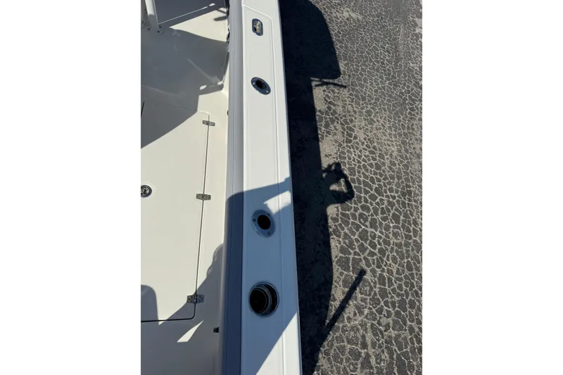 Slide: The Image of 2026 Pathfinder 2400 Open boat deck with rod holders and storage compartment. - 47