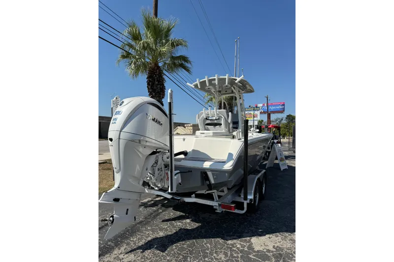 Slide: The Image of 2026 Pathfinder 2400 Open boat with Yamaha engine on trailer, parked under clear blue sky. - 48