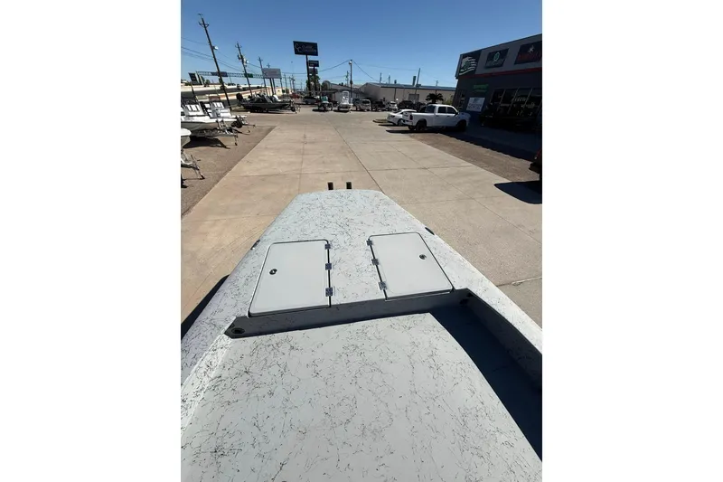 Slide: The Image of 2026 Freedom Boats 24 Defender on display at a dealership, showcasing deck features. - 9