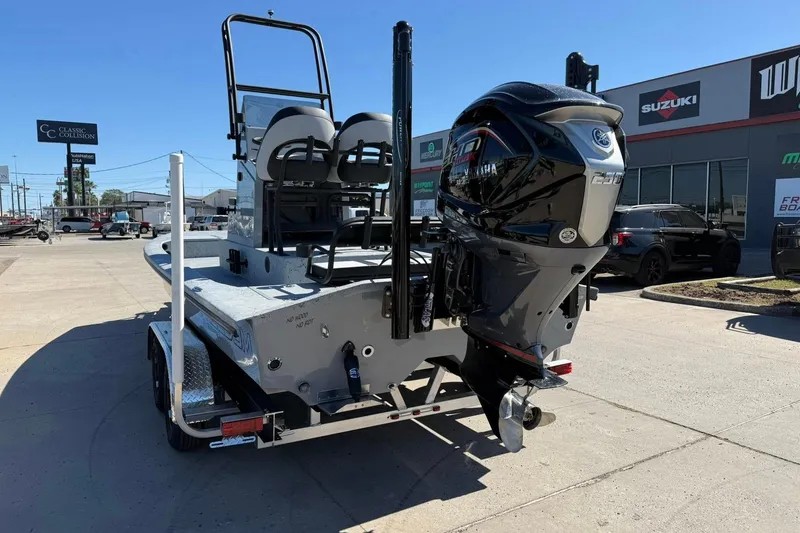 Slide: The Image of 2026 Freedom Boats 24 Defender with powerful outboard motor on trailer. - 1