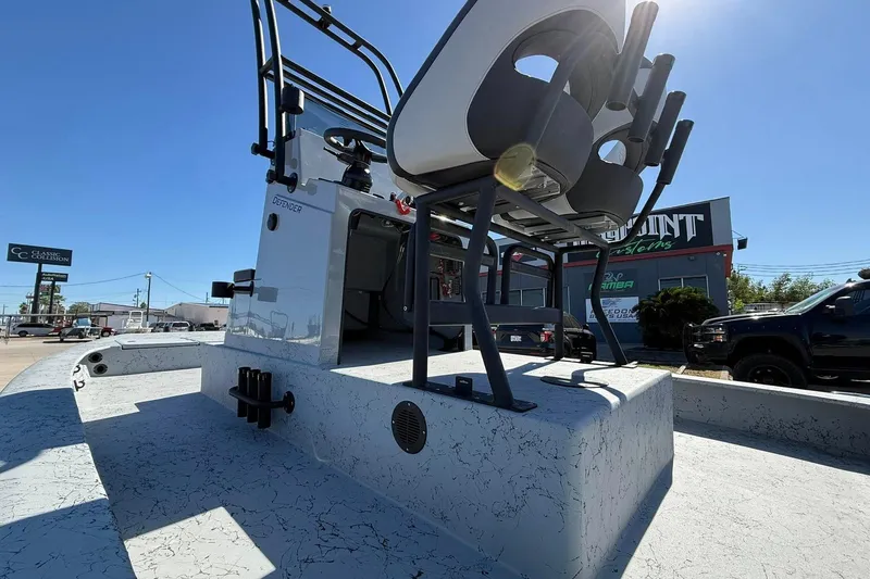 Slide: The Image of 2026 Freedom Boats 24 Defender, showcasing deck and seating, in a sunny outdoor setting. - 4