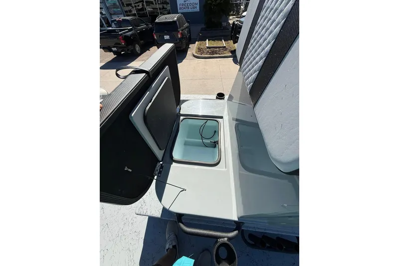 Slide: The Image of 2026 Freedom Boats 24 Defender interior storage compartment with open hatch. - 5