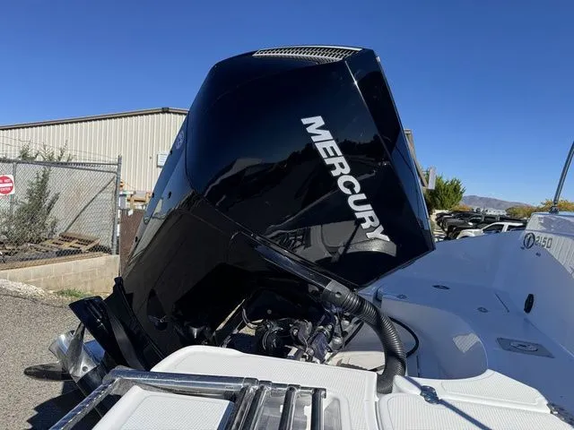Slide: The Image of 2020 Tahoe 2150 boat with Mercury outboard motor in a sunny outdoor setting. - 10