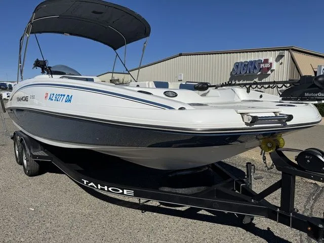 Slide: The Image of 2020 Tahoe 2150 boat on trailer, parked outdoors under clear sky. - 15