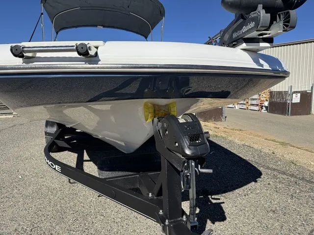 Slide: The Image of 2020 Tahoe 2150 boat on trailer with trolling motor, parked outdoors. - 17