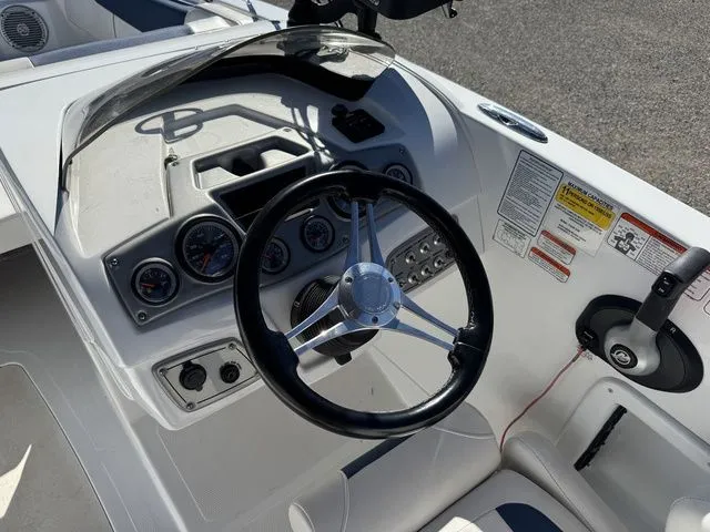 Slide: The Image of 2020 Tahoe 2150 boat dashboard with steering wheel and control gauges. - 23