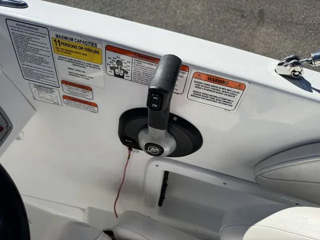 Slide: The Image of Boat control panel of a 2020 Tahoe 2150, featuring throttle and safety warnings. - 24