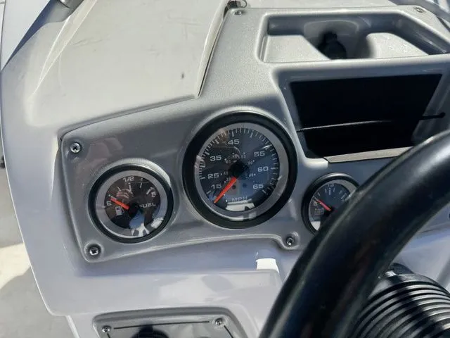 Slide: The Image of Dashboard of a 2020 Tahoe 2150 boat with speedometer and fuel gauge. - 26