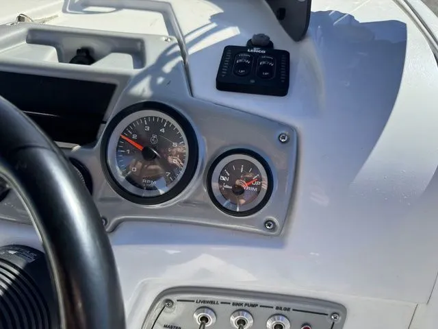 Slide: The Image of Dashboard of a 2020 Tahoe 2150 boat with gauges and controls. - 27