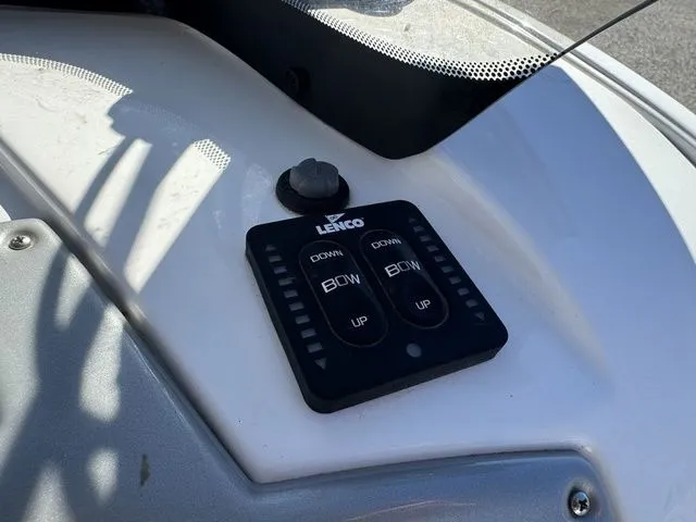 Slide: The Image of Lenco trim tab control on 2020 Tahoe 2150 boat dashboard. - 28