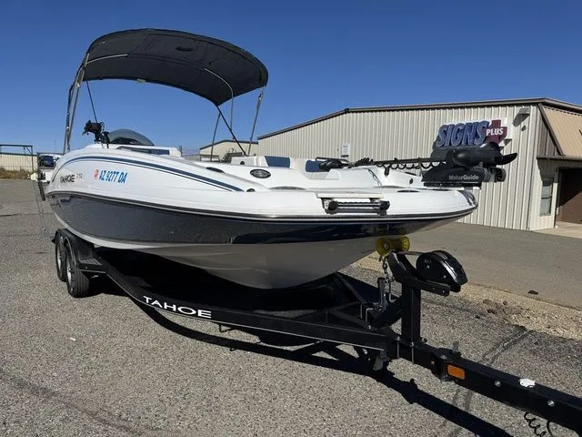Slide: The Image of 2020 Tahoe 2150 boat on trailer, parked outdoors near a building. - 3