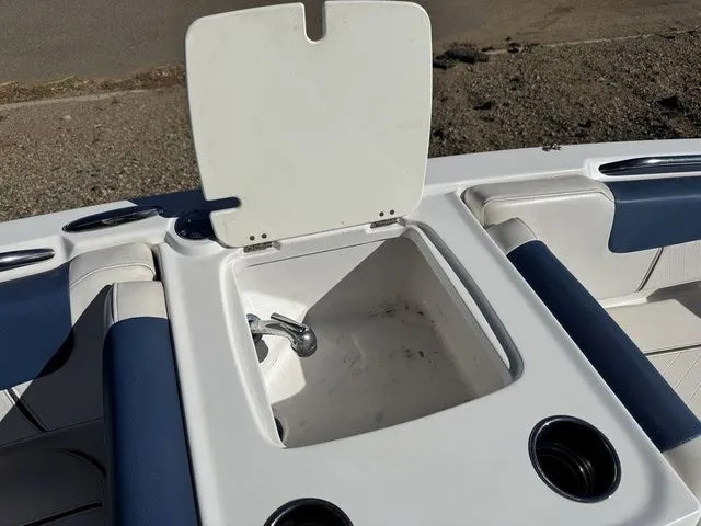 Slide: The Image of Open storage compartment on a 2020 Tahoe 2150 boat with cup holders. - 32