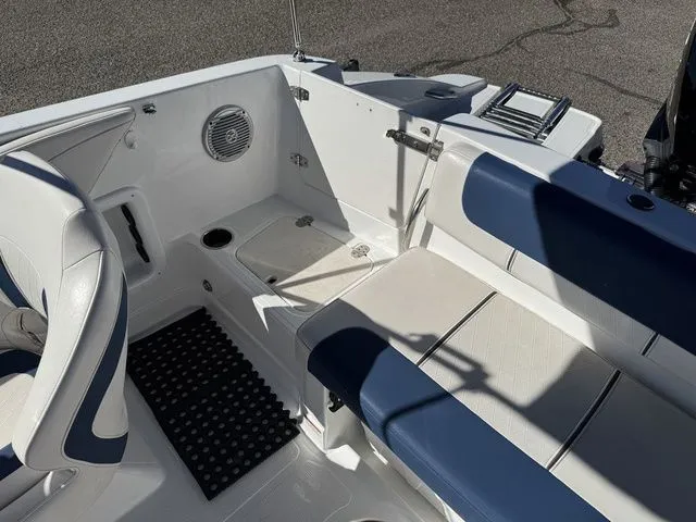 Slide: The Image of 2020 Tahoe 2150 boat interior with blue and white seating and deck features. - 35