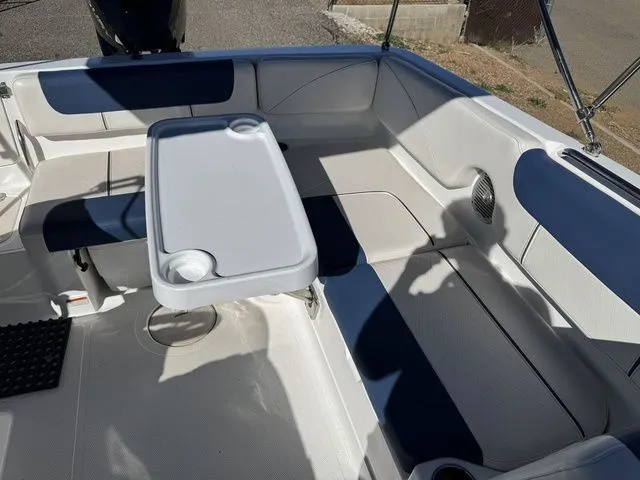Slide: The Image of 2020 Tahoe 2150 boat interior with seating and table, featuring blue and white upholstery. - 38