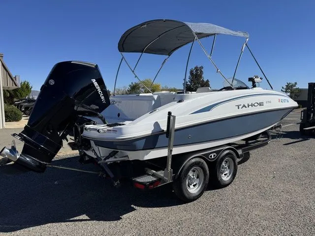 Slide: The Image of 2020 Tahoe 2150 boat with Mercury outboard motor on a trailer. - 4