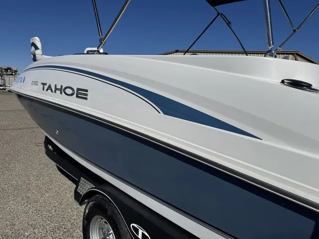 Slide: The Image of 2020 Tahoe 2150 boat side view with sleek design and blue accents. - 47