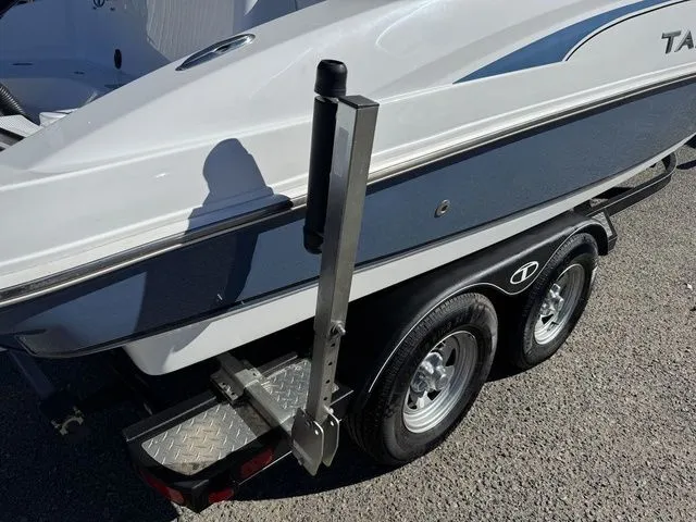 Slide: The Image of 2020 Tahoe 2150 boat on trailer, featuring dual wheels and a sleek design. - 9