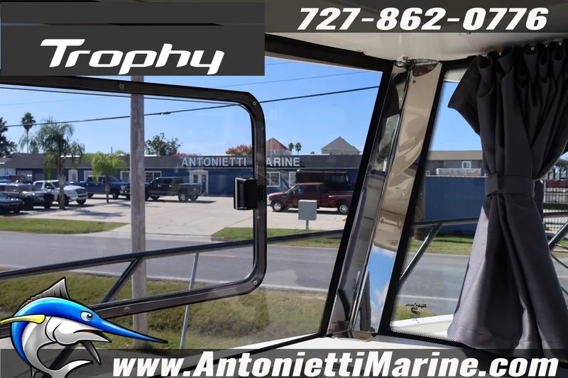 Slide: The Image of 2025 Trophy T 25 Pilothouse interior view with window and curtain, Antonietti Marine dealership. - 16