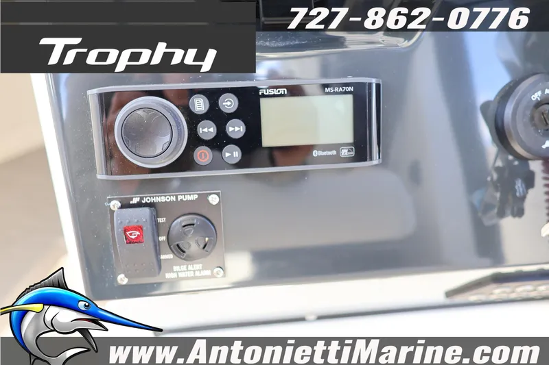 Slide: The Image of Control panel of 2025 Trophy T 25 Pilothouse boat with audio system and pump controls. - 32