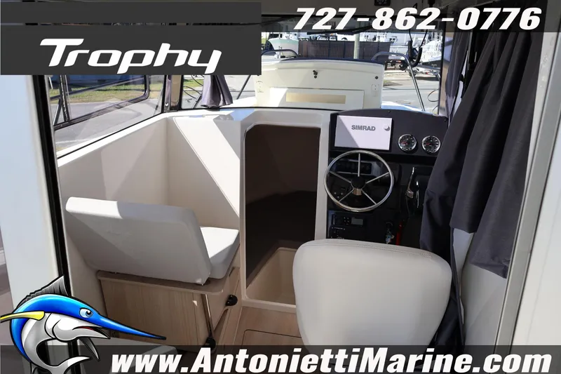 Slide: The Image of 2025 Trophy T 25 Pilothouse interior with steering wheel and seating, Antonietti Marine branding. - 34
