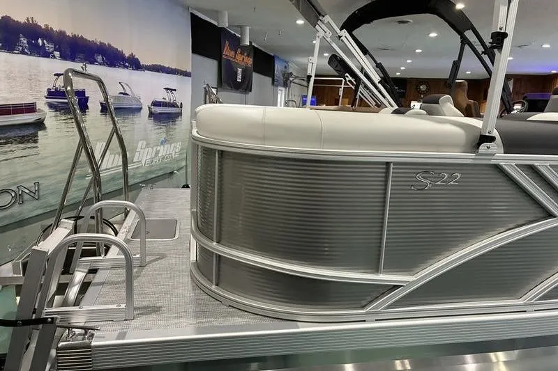 Slide: The Image of 2026 Bennington SX 22 SLX pontoon boat displayed indoors with sleek design. - 7
