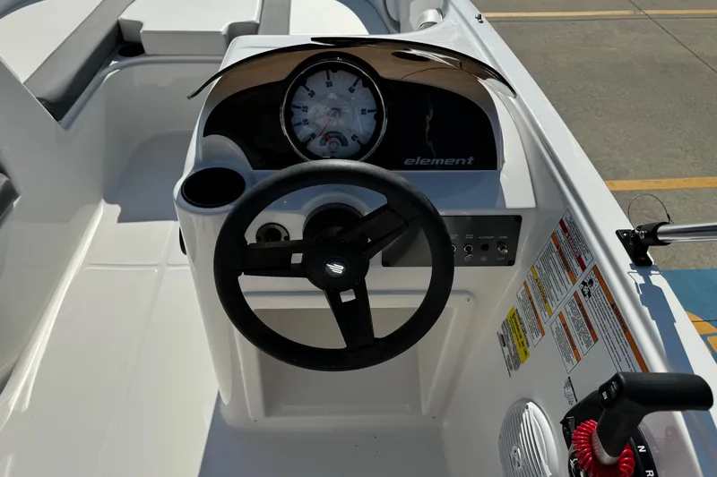 Slide: The Image of 2025 Bayliner Element E16 boat dashboard with steering wheel and instrument panel. - 12