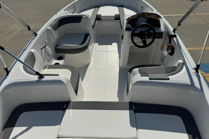 Slide: The Image of 2025 Bayliner Element E16 boat interior with seating and steering console. - 5