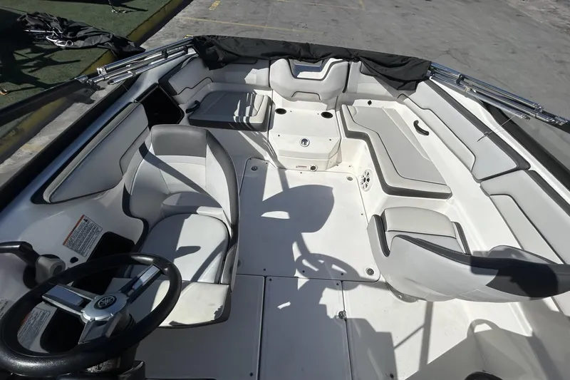 Slide: The Image of 2019 Yamaha Boats SX190 interior with seating and steering wheel, showcasing spacious design. - 13